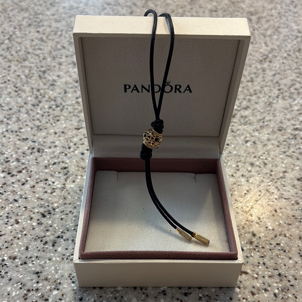 Pandora Black Leather Cord Necklace with 14kt Gold charm with 14kt Gold pieces.